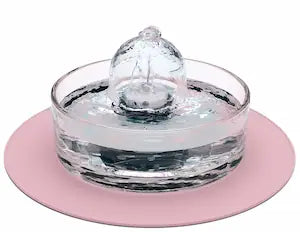 Brook fountain on a pink splash mat