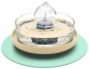Brook fountain on a beige and green stand and splash mat