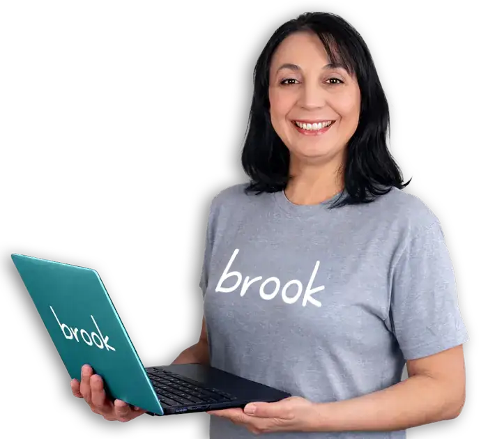 Nuran from Brook customer support, smiling and holding a teal Brook laptop.